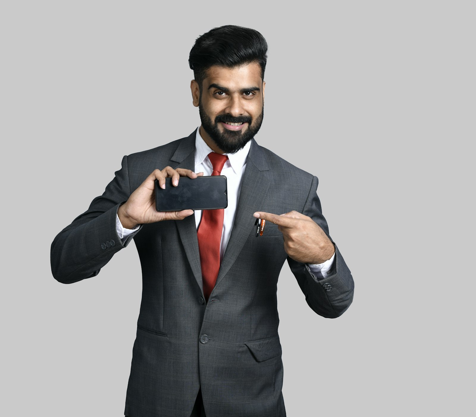 Seller pointing at the PrimeNest app on his phone
